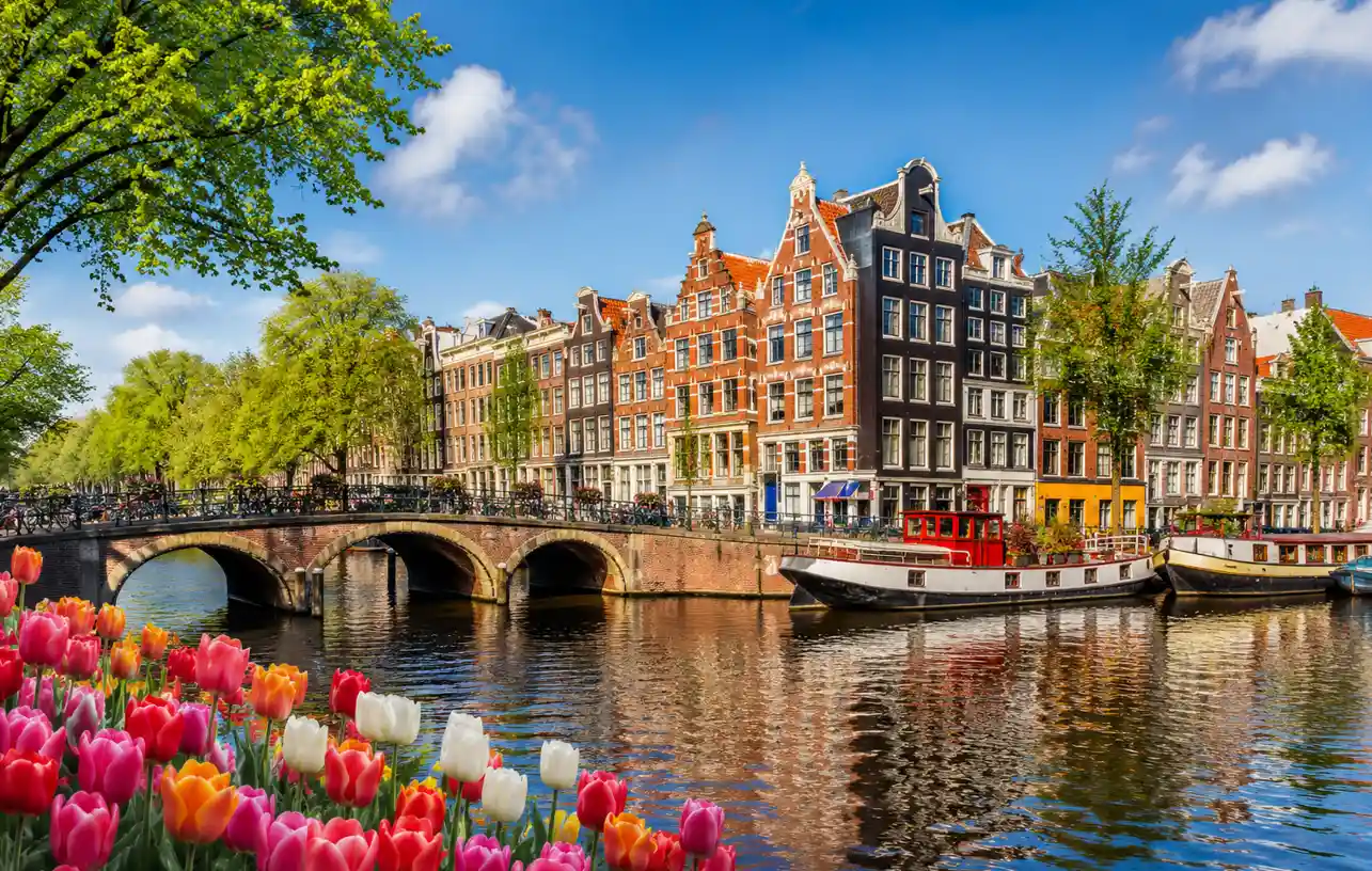 Netherlands visit visa from Qatar with Amsterdam canal tourism view